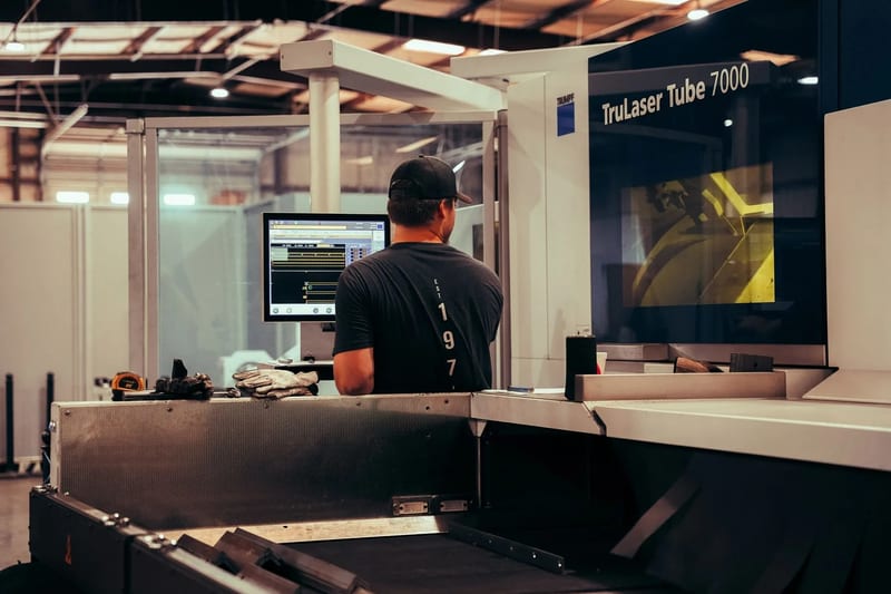 An operator at the TRUMPF TruLaser Tube 7000 in the THG fabrication shop