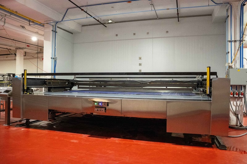 Wide stainless oven loader with a blue conveying belt